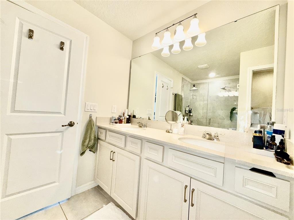 2208 Gopher Tortoise Terrace Oakland, FL 34787 - Photo 29 of 50 a bathroom with a double vanity sink mirror and