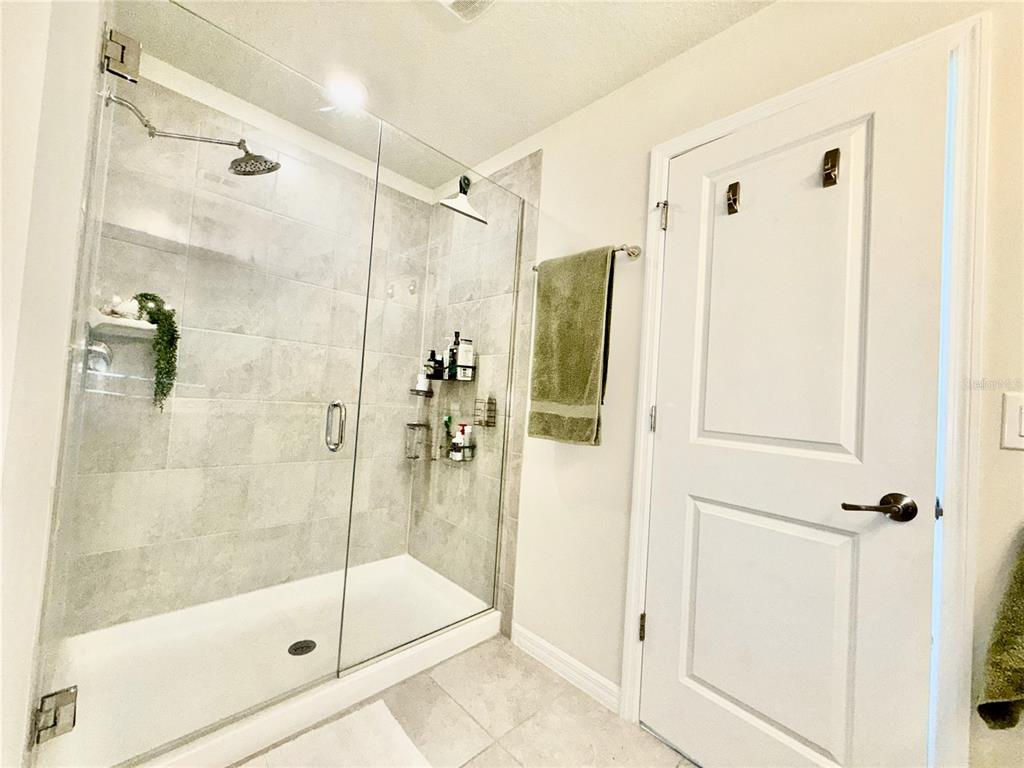 2208 Gopher Tortoise Terrace Oakland, FL 34787 - Photo 30 of 50 a bathroom with a shower and a glass door