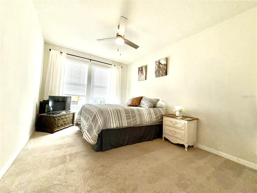 2208 Gopher Tortoise Terrace Oakland, FL 34787 - Photo 37 of 50 a bedroom with a bed and a window