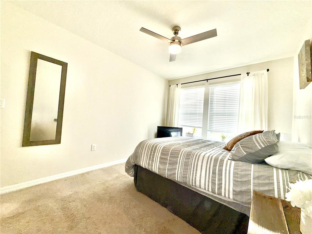 2208 Gopher Tortoise Terrace Oakland, FL 34787 - Photo 39 of 50 a bedroom with a bed and a chandelier