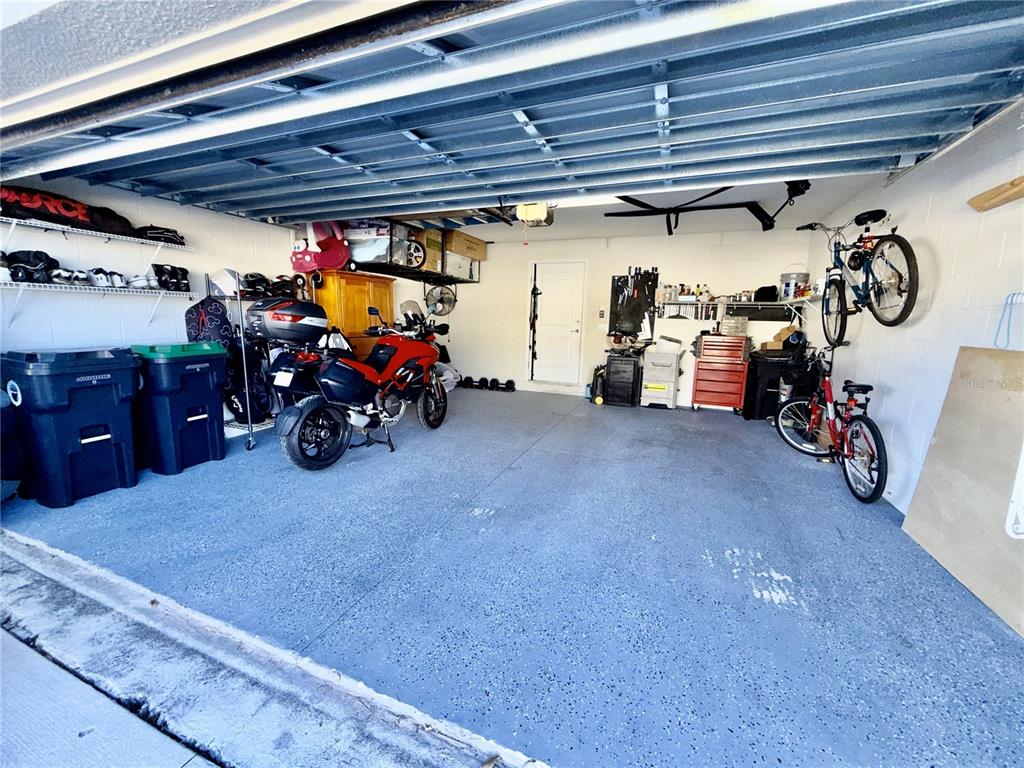 2208 Gopher Tortoise Terrace Oakland, FL 34787 - Photo 40 of 50 a view of a garage with rack and bicycle
