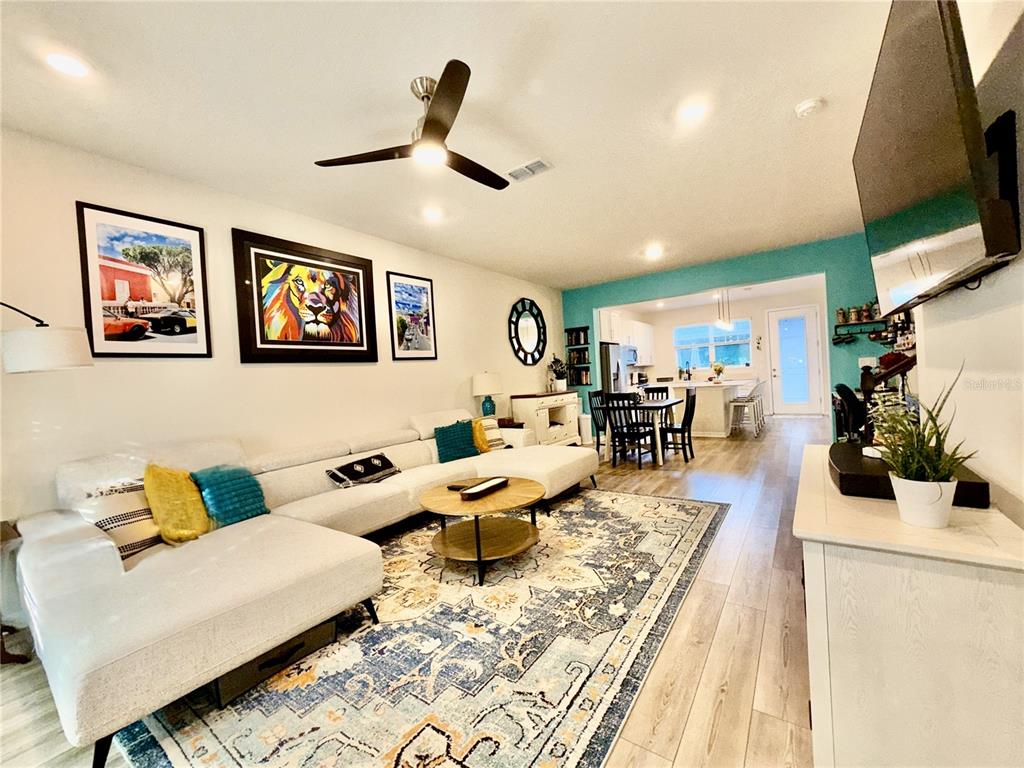 2208 Gopher Tortoise Terrace Oakland, FL 34787 - Photo 5 of 50 a living room with furniture and a flat screen tv