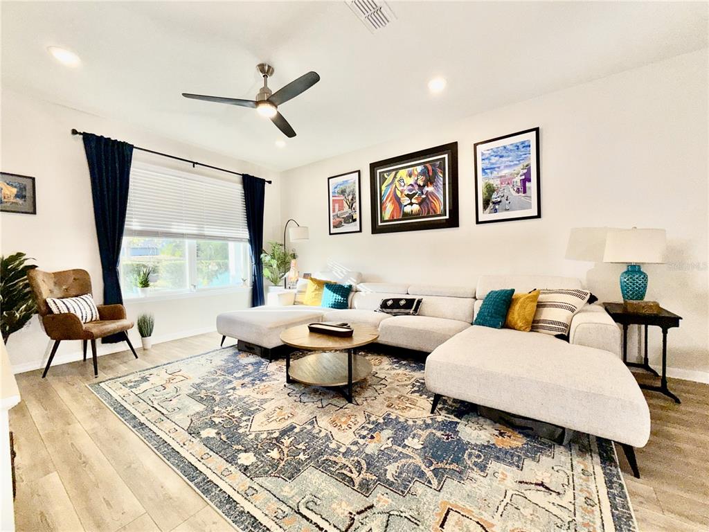 2208 Gopher Tortoise Terrace Oakland, FL 34787 - Photo 6 of 50 a living room with furniture and a large window