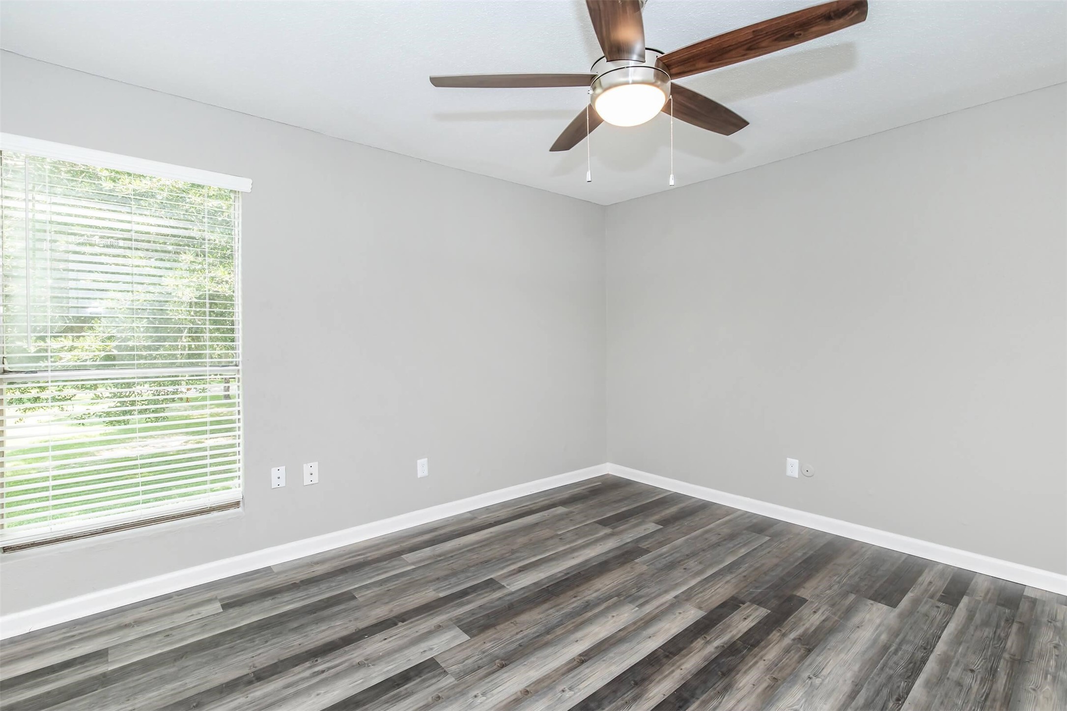 18001 Cypress Trace Road, Unit 1301 Houston, TX 77090 - Photo 10 of 34 wooden floor in an empty room with a window