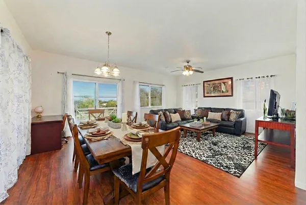 a living room with lots of furniture and wooden floor