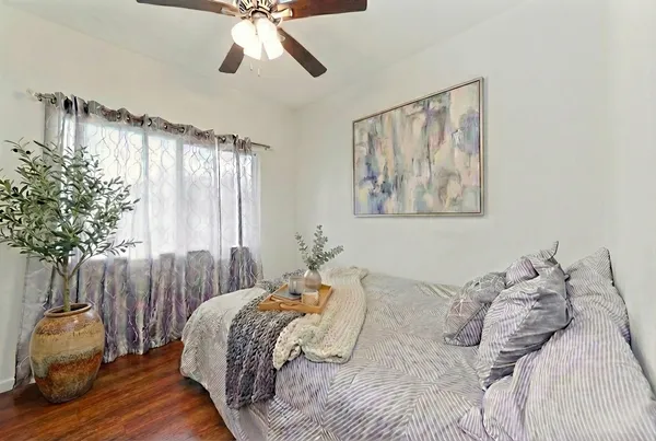 a bedroom with a bed and a chandelier