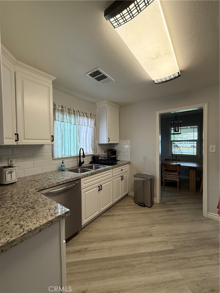 1025 Davids Road Perris, CA 92571 - Photo 3 of 13 a kitchen with stainless steel appliances granite countertop a sink and cabinets