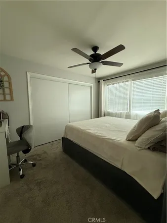 a bedroom with a bed a desk and chair