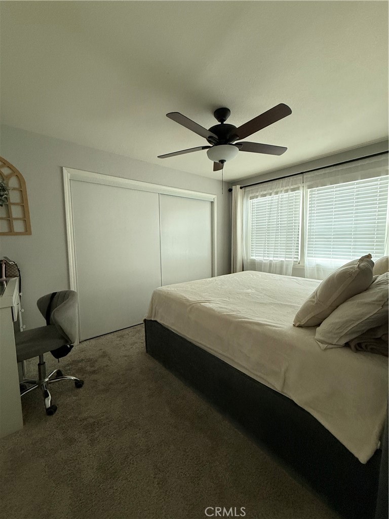 1025 Davids Road Perris, CA 92571 - Photo 10 of 13 a bedroom with a bed a desk and chair