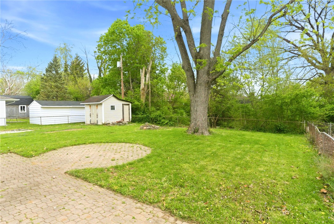 40 Woods Road Springboro, OH 45066 - Photo 9 of 57 This spacious yard offers ample green space and a convenient shed for outdoor storage.