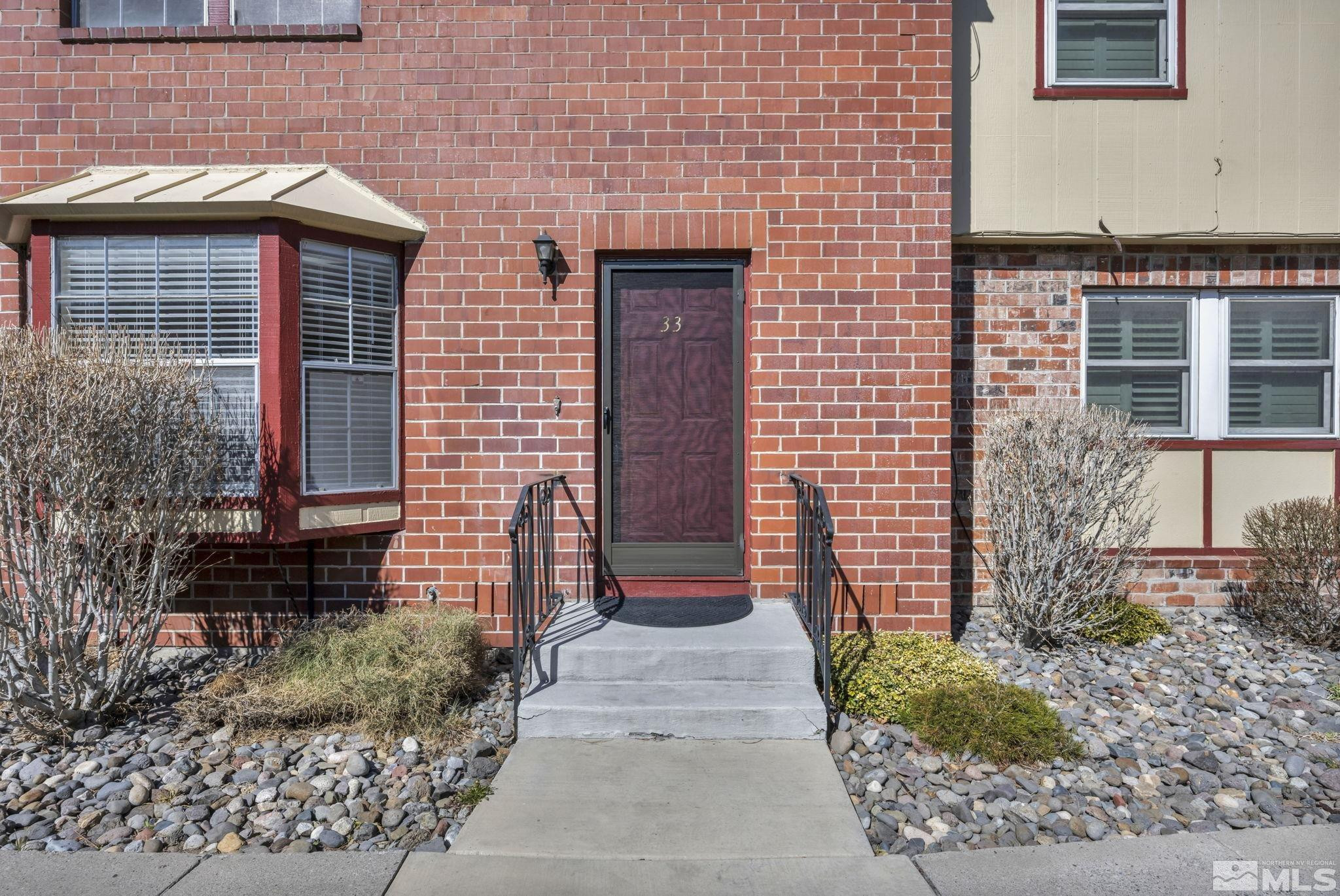 435 Pine Meadows Drive, Unit 33 Sparks, NV 89431 - Photo 1 of 17 a front view of a house with a garden