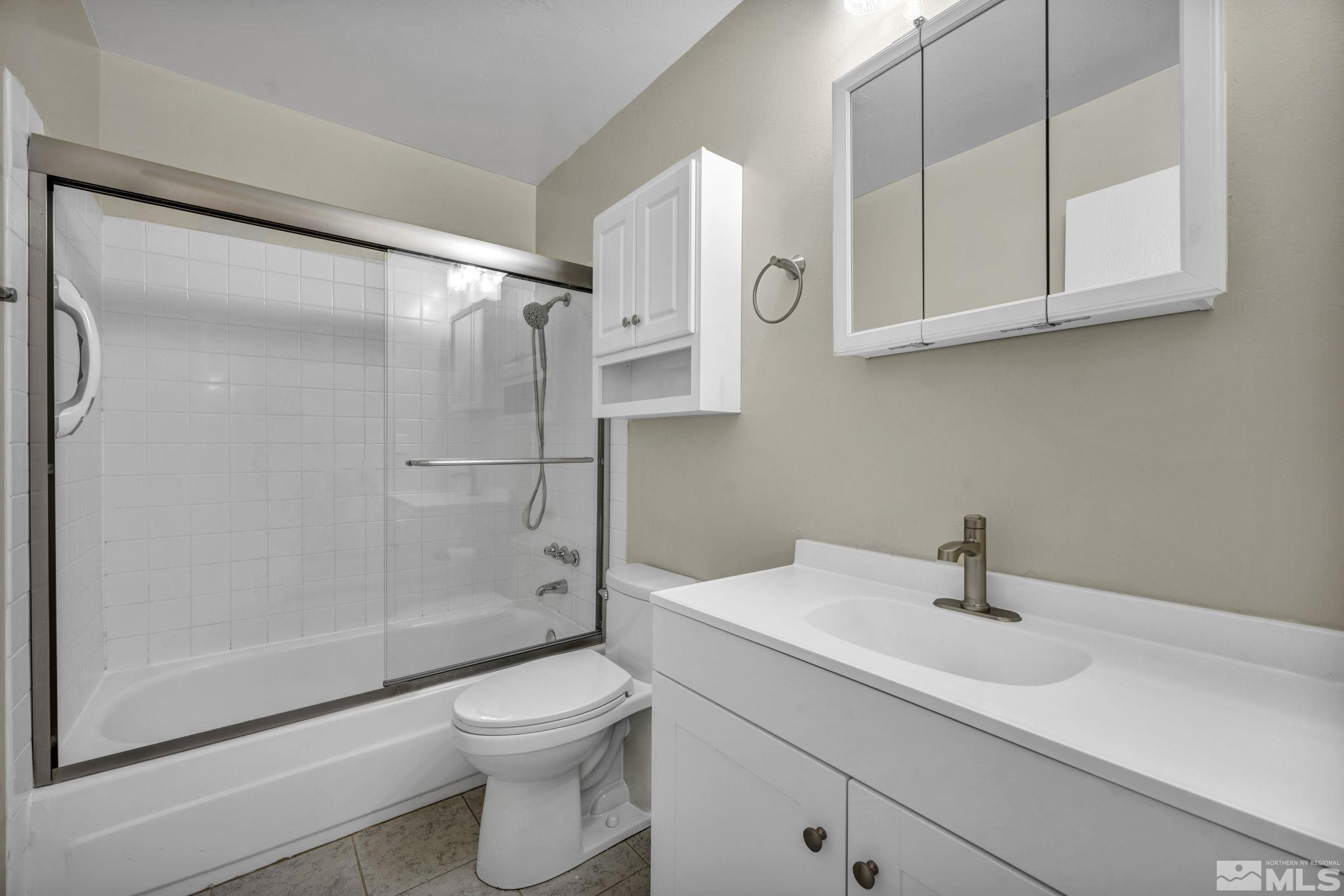 435 Pine Meadows Drive, Unit 33 Sparks, NV 89431 - Photo 11 of 17 a bathroom with a sink a toilet and shower