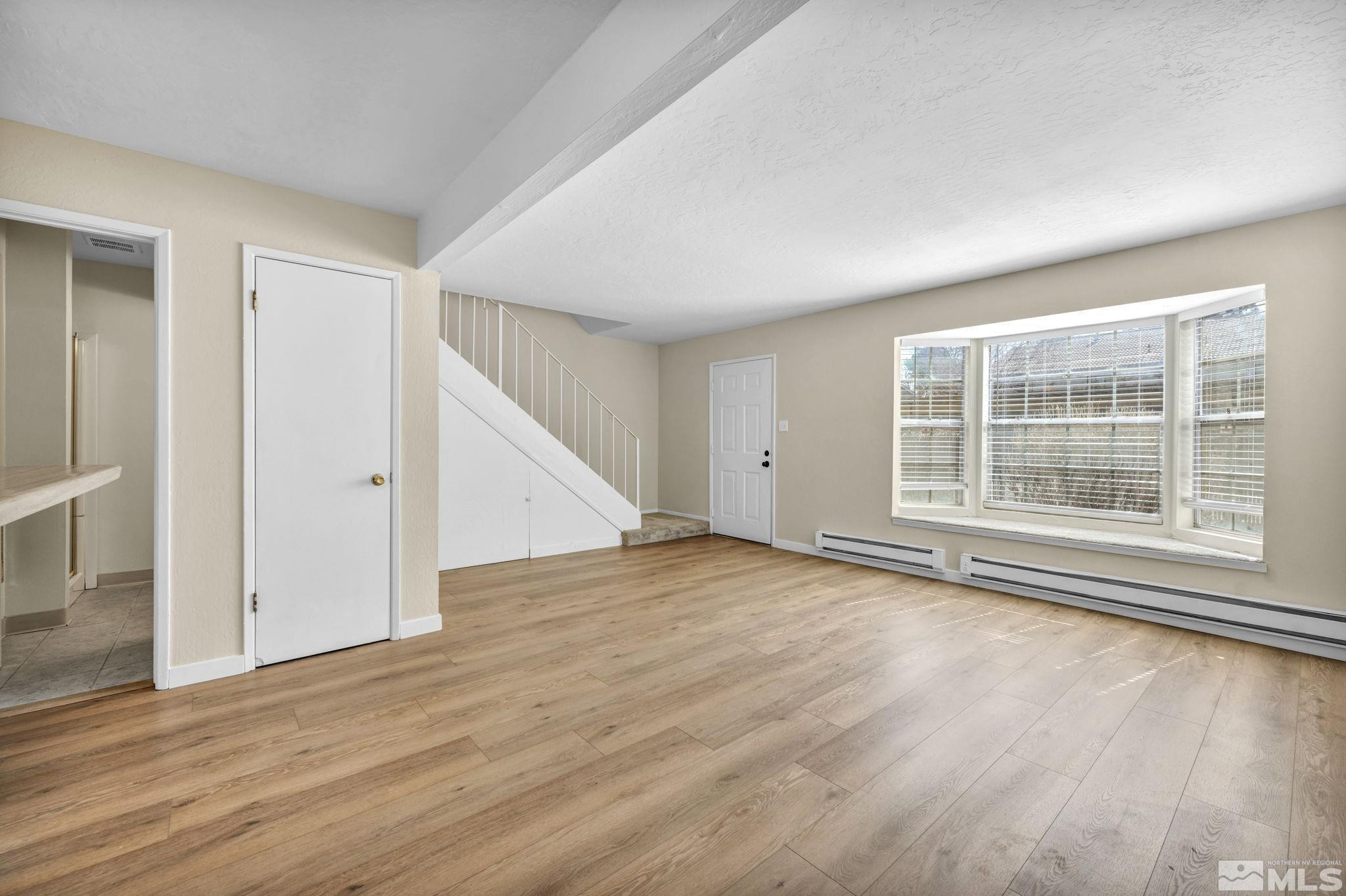 435 Pine Meadows Drive, Unit 33 Sparks, NV 89431 - Photo 2 of 17 a view of empty room with wooden floor and fan
