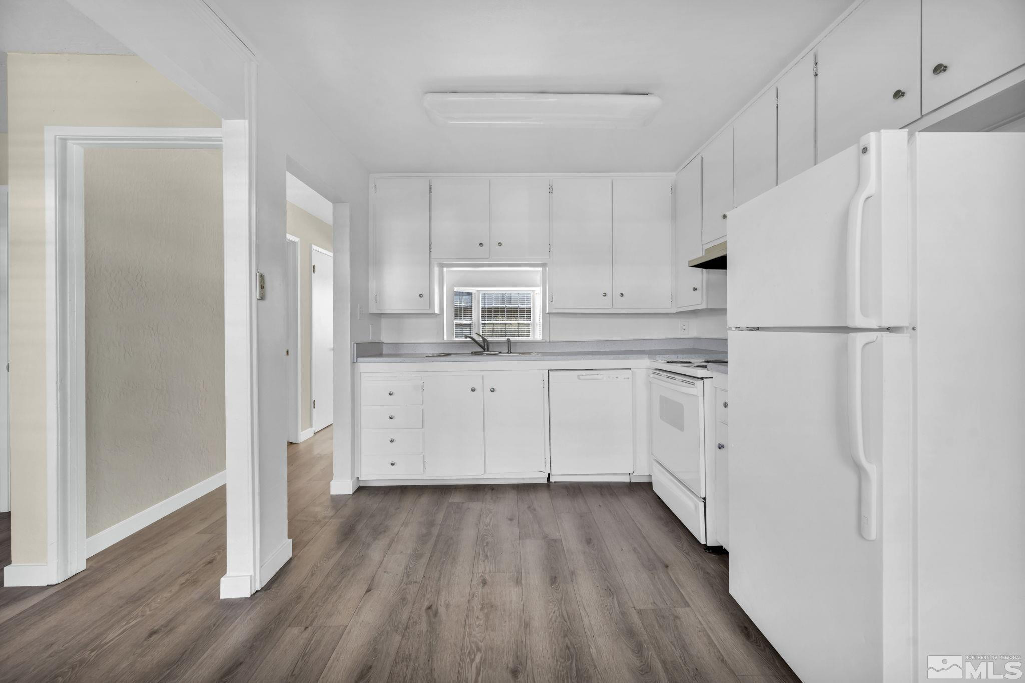 435 Pine Meadows Drive, Unit 33 Sparks, NV 89431 - Photo 4 of 17 a kitchen with white cabinets and white appliances