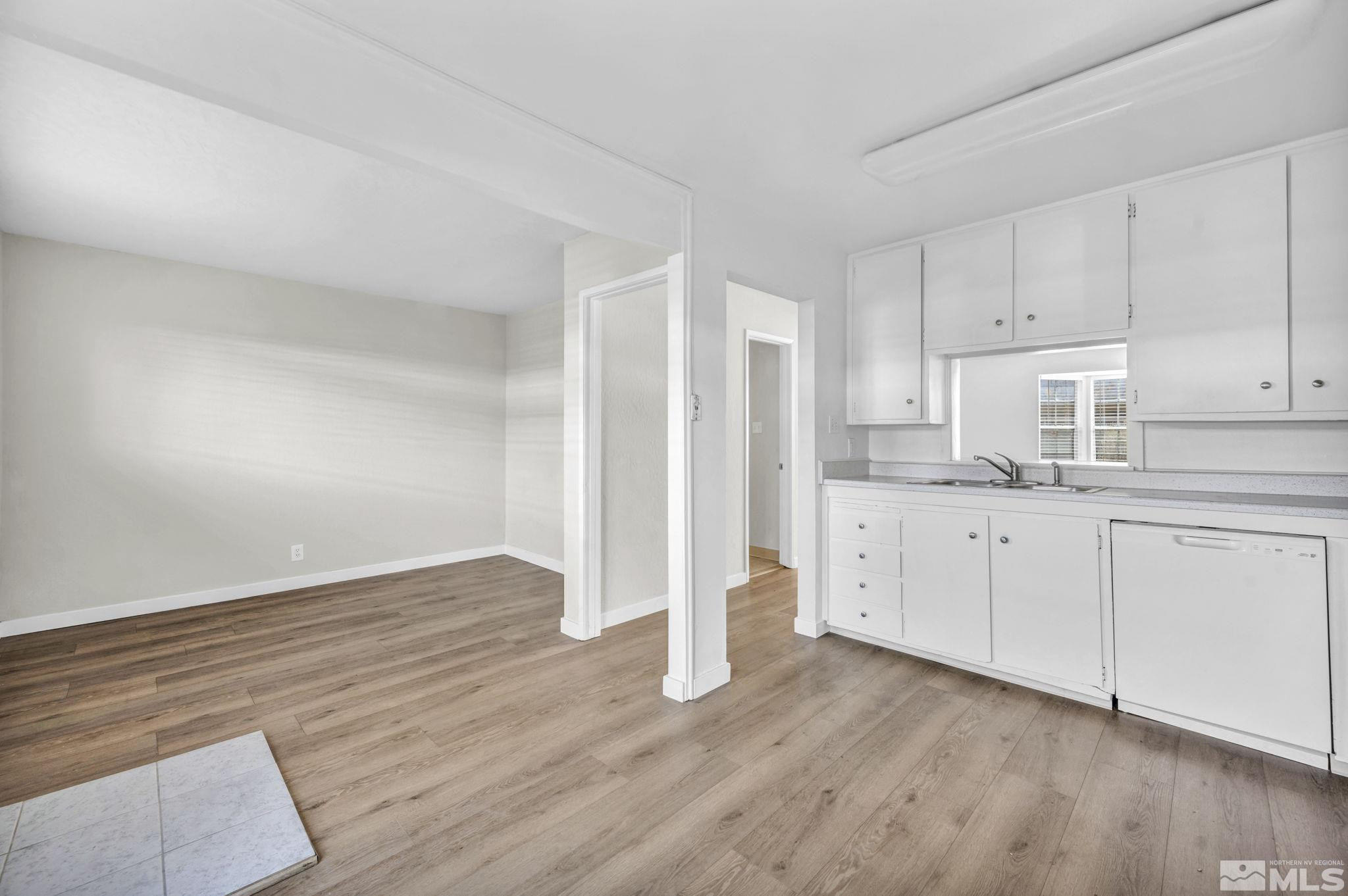 435 Pine Meadows Drive, Unit 33 Sparks, NV 89431 - Photo 5 of 17 a kitchen with wooden floors and white cabinets