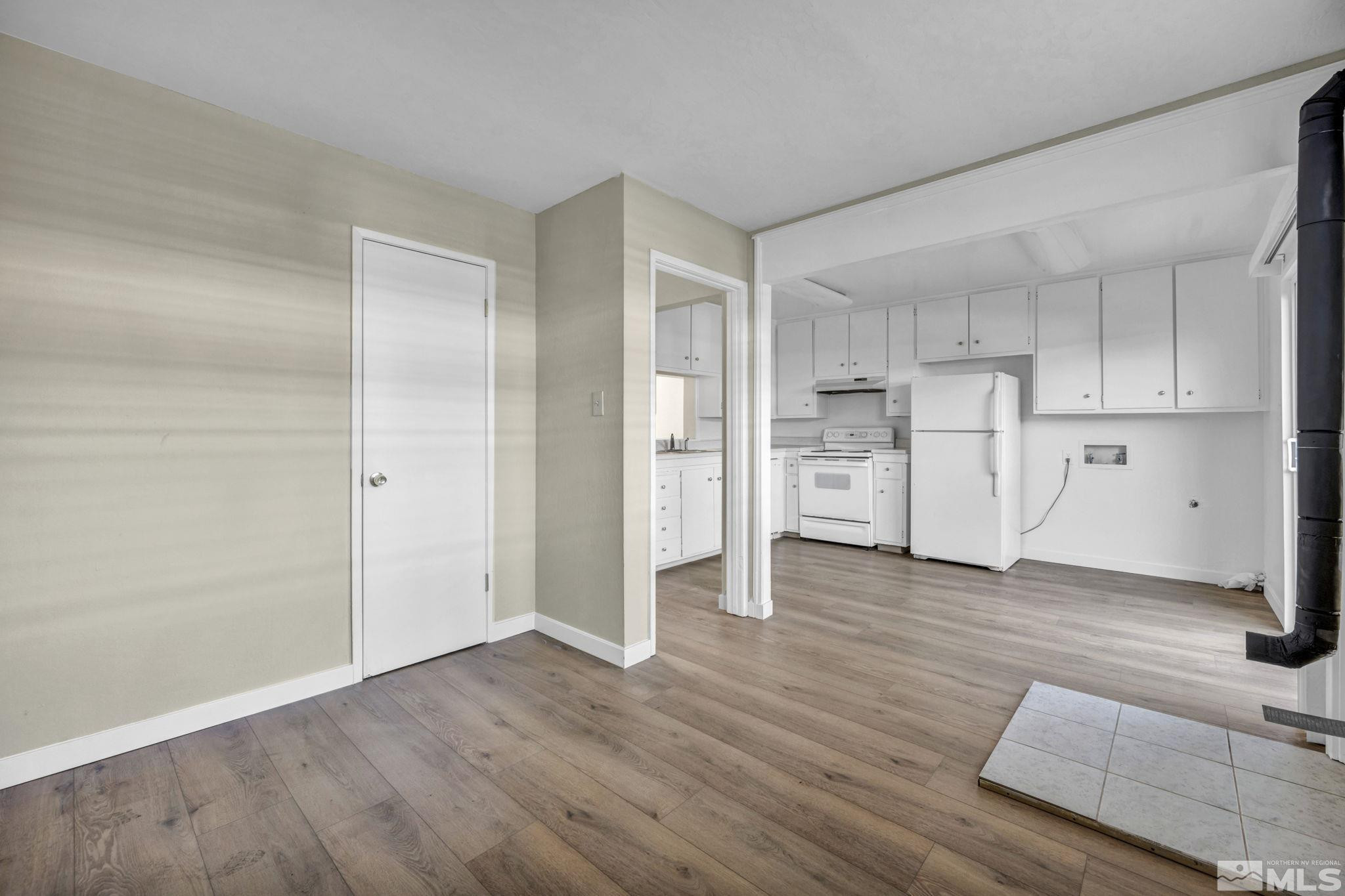 435 Pine Meadows Drive, Unit 33 Sparks, NV 89431 - Photo 6 of 17 a view of a kitchen with wooden floor and a refrigerator