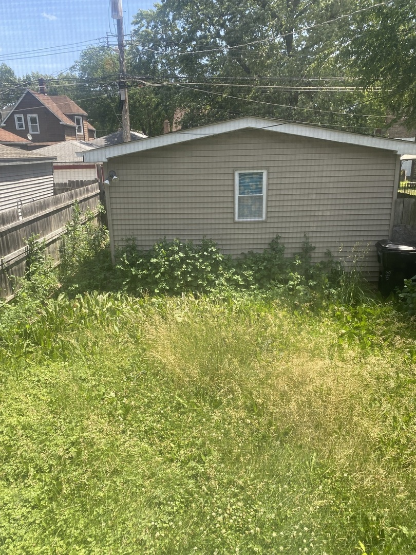 8611 South Aberdeen Street Chicago, IL 60620 - Photo 12 of 12 a backyard of a house with lots of green space