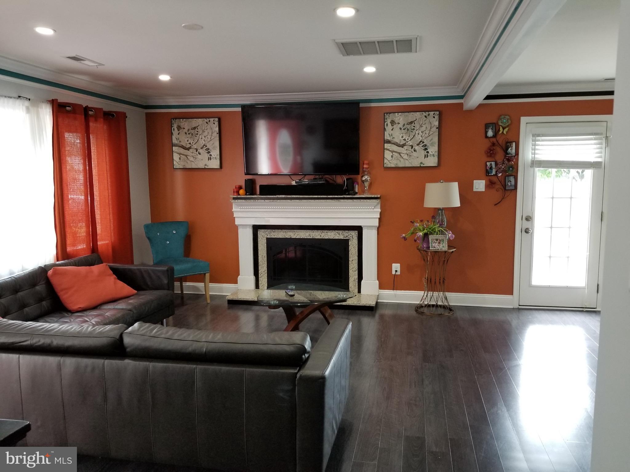 6218 Apache Street Springfield, VA 22150 - Photo 3 of 30 a living room with furniture and a fireplace