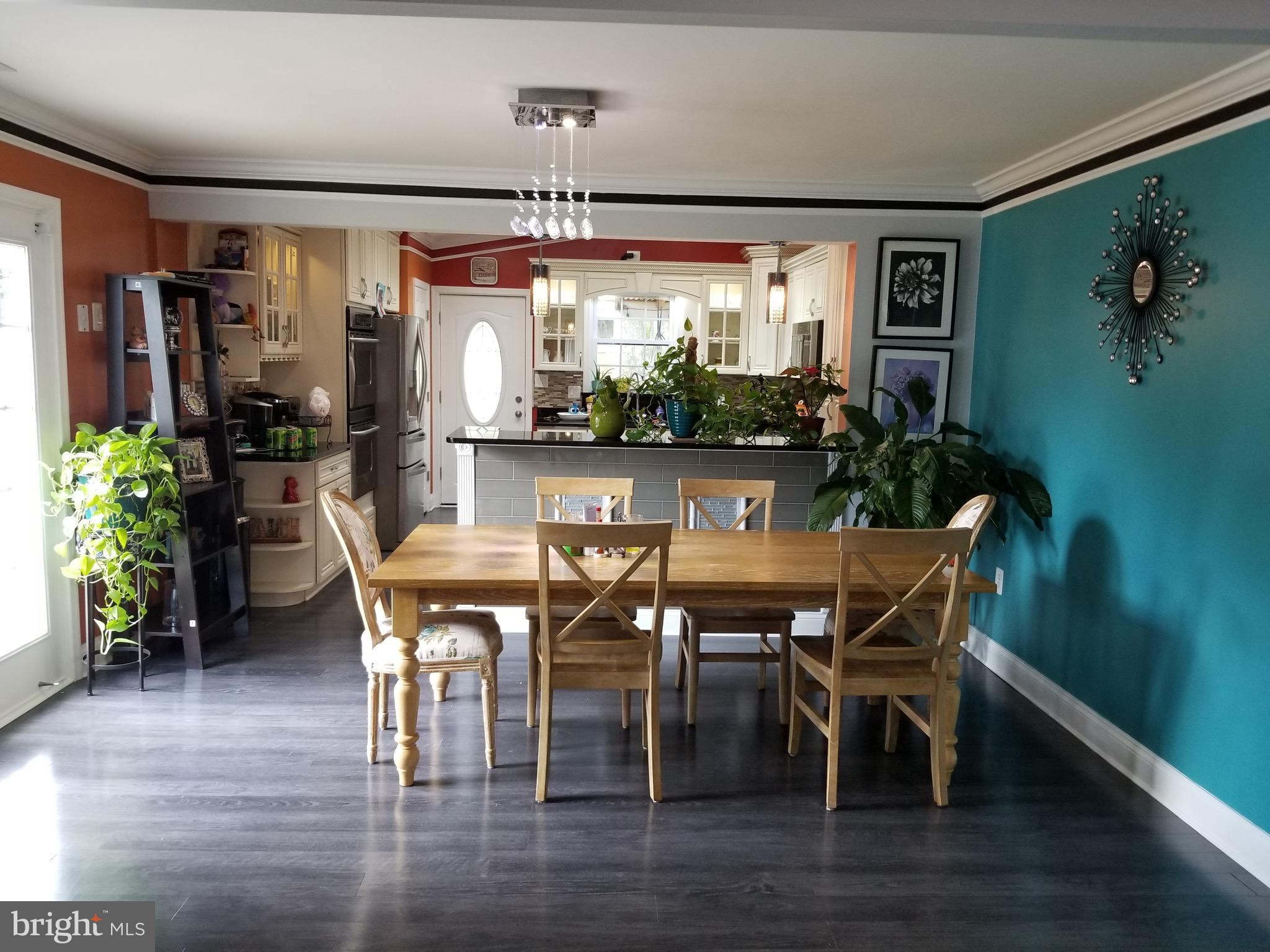 6218 Apache Street Springfield, VA 22150 - Photo 5 of 30 a view of a dining room with furniture window and wooden floor