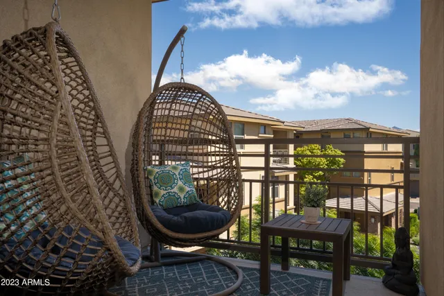 a bedroom with a bed a chandelier and a dresser