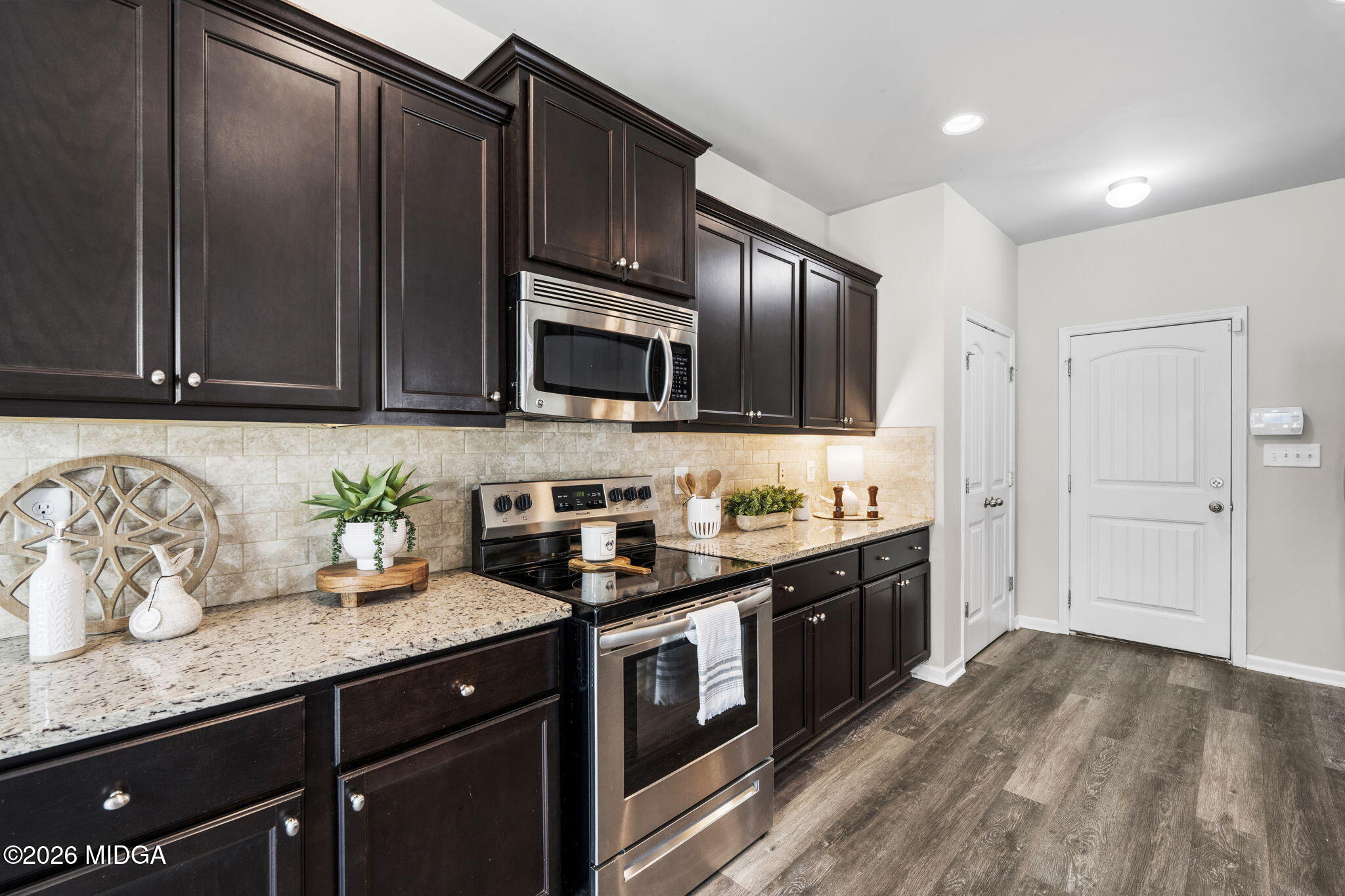184 Amelia Drive, Unit 162 Byron, GA 31008 - Photo 17 of 46 a kitchen with granite countertop stainless steel appliances and wooden cabinets