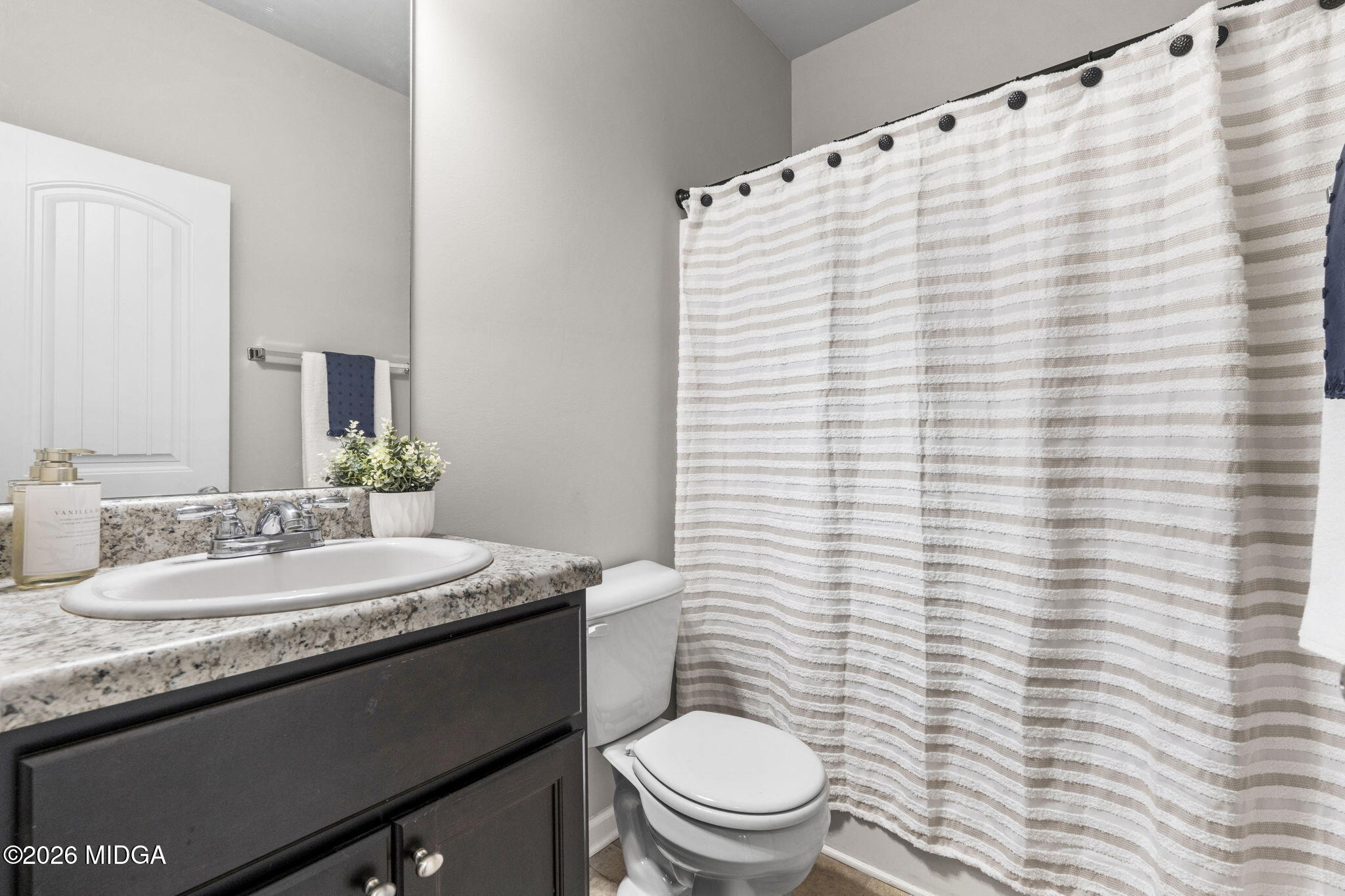 184 Amelia Drive, Unit 162 Byron, GA 31008 - Photo 22 of 46 a bathroom with a granite countertop sink toilet and mirror