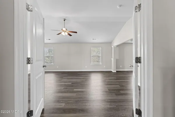 a view of a kitchen with a hardwood floor and a ceiling fan