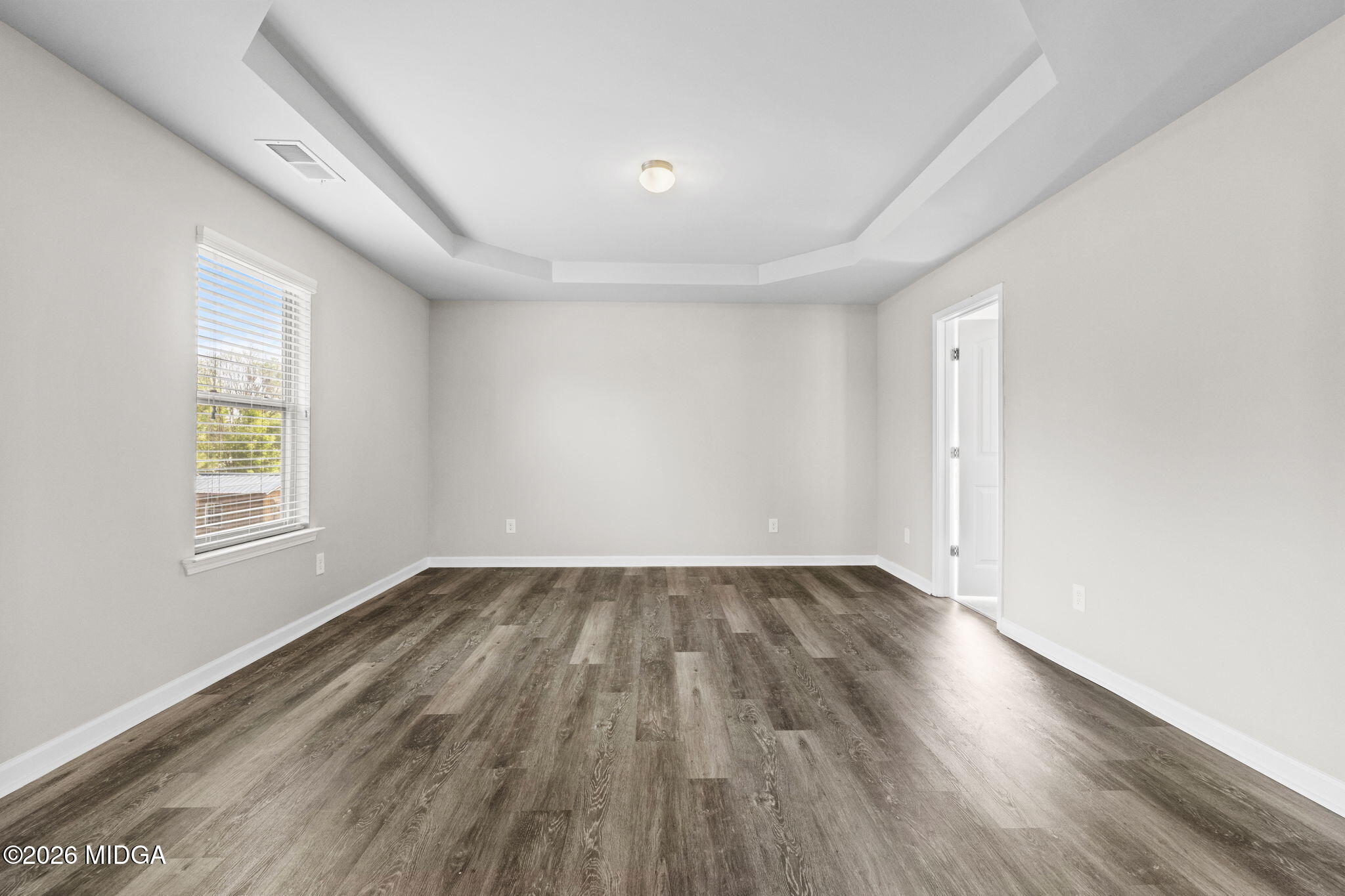 184 Amelia Drive, Unit 162 Byron, GA 31008 - Photo 34 of 46 an empty room with wooden floor and windows