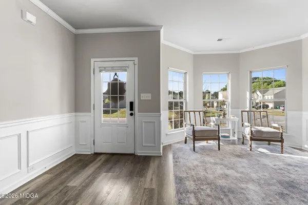 a view of a livingroom with furniture wooden floor and windows