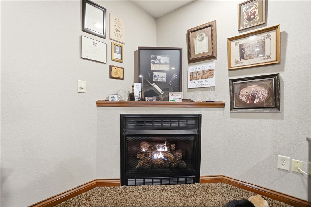 5300 Brookshire Lane Springfield, OH 45502 - Photo 46 of 56 This inviting corner fireplace offers a warm and cozy focal point.