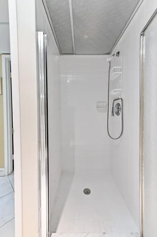 a bathroom with a glass shower door