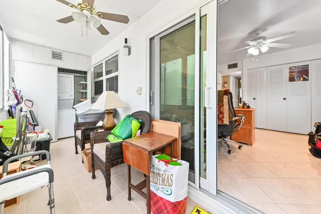 a living room filled with furniture gym equipment and a chandelier