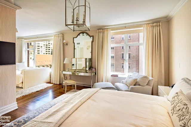 a bedroom with a bed and a mirror