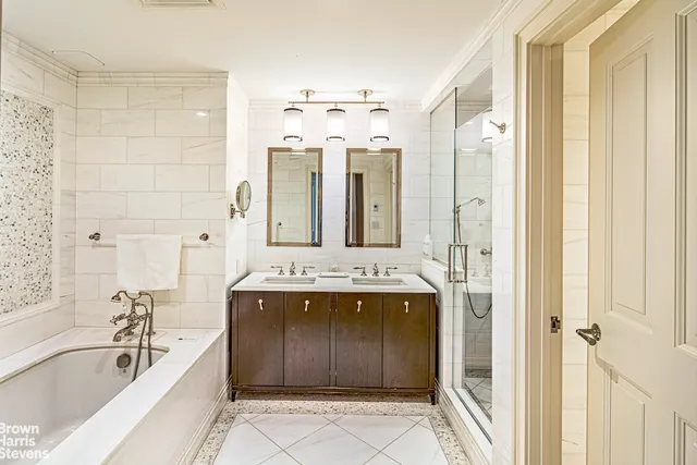 a bedroom with a bed a couch and dresser