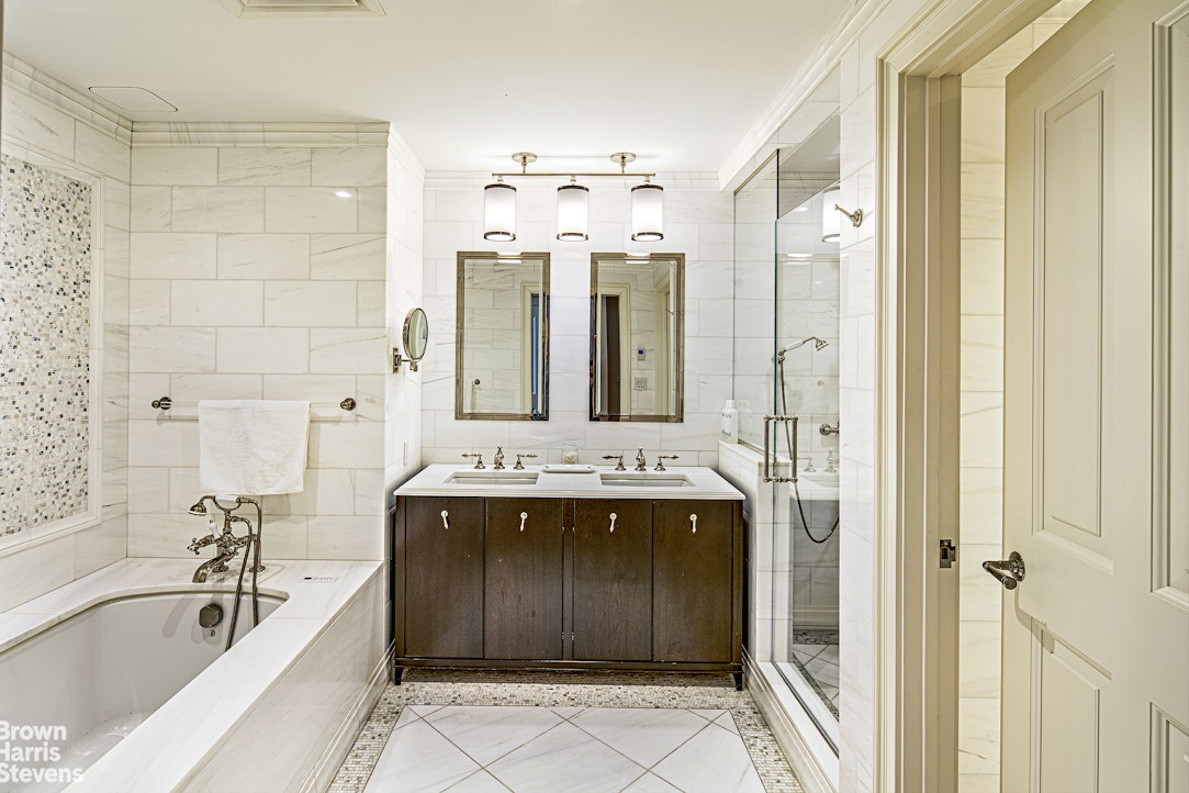 535 West End Avenue, Unit 8B Manhattan, NY 10024 - Photo 12 of 16 a bathroom with a tub sink and mirror