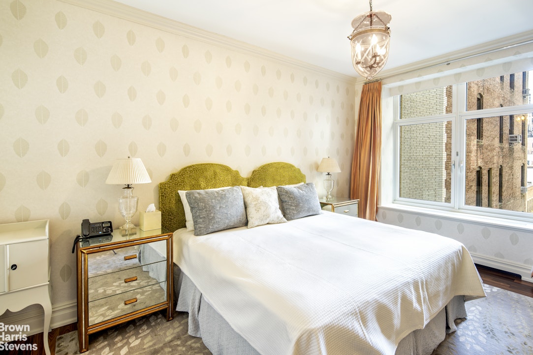 535 West End Avenue, Unit 8B Manhattan, NY 10024 - Photo 13 of 16 a bedroom with a bed and a chandelier