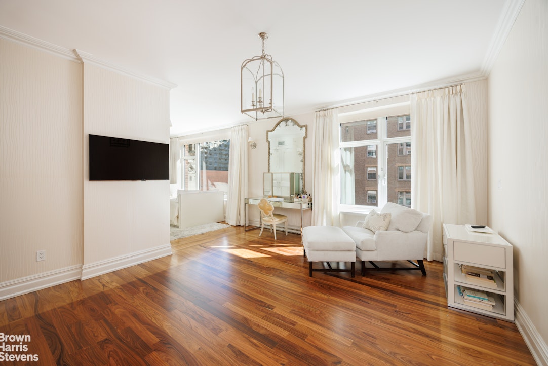 535 West End Avenue, Unit 8B Manhattan, NY 10024 - Photo 15 of 16 a living room with furniture and a flat screen tv
