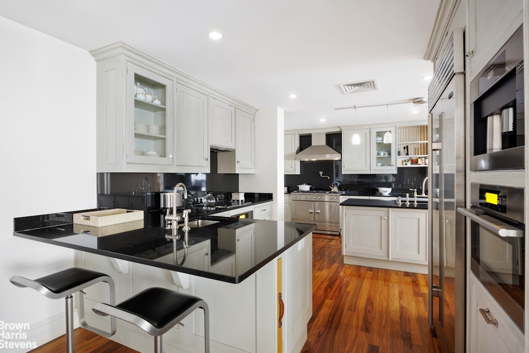 535 West End Avenue, Unit 8B Manhattan, NY 10024 - Photo 7 of 16 a kitchen with stainless steel appliances granite countertop a sink a stove top oven a counter space and cabinets