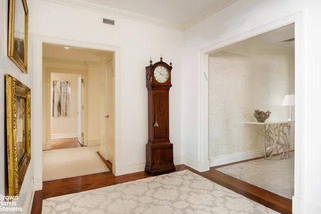 a kitchen with stainless steel appliances kitchen island granite countertop a sink a stove and a wooden floors