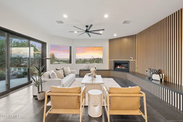 a dining room with furniture a fireplace and wooden floor