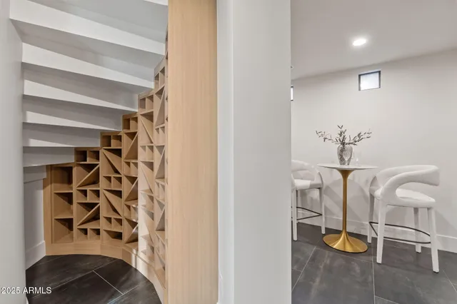 a living room with furniture and a painting on the wall