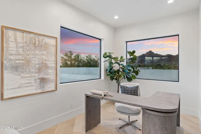 a large bedroom with a large bed and glass door