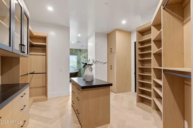 a view of a storage and utility room with washer and dryer