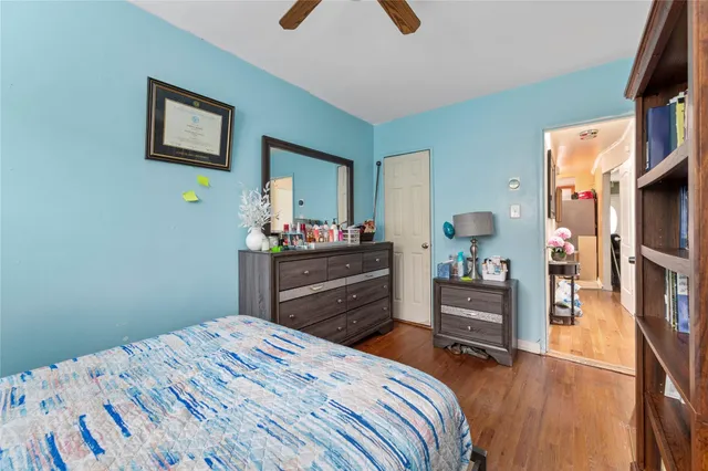 a bedroom with a bed and a dresser in it