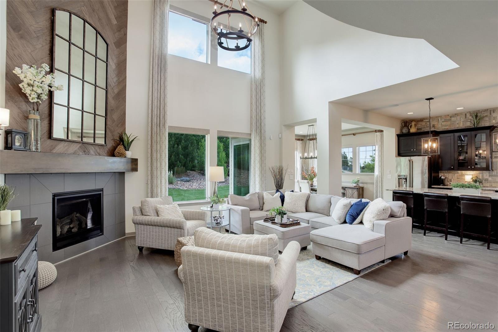 23451 East Rockinghorse Parkway Aurora, CO 80016 - Photo 11 of 36 a living room with furniture and a fireplace
