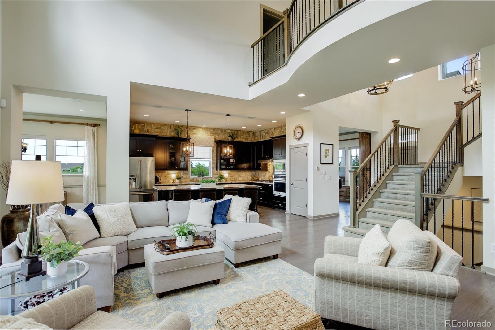23451 East Rockinghorse Parkway Aurora, CO 80016 - Photo 12 of 36 a living room with furniture and wooden floor