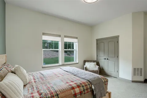 a bedroom with a bed and a large window