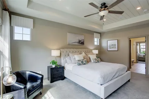a bedroom with a bed and ceiling fan
