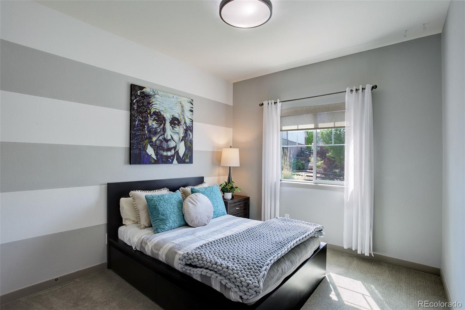 23451 East Rockinghorse Parkway Aurora, CO 80016 - Photo 19 of 36 a bedroom with a bed and a window