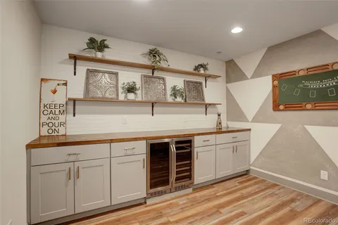 a view of cabinets a wooden floor and windows